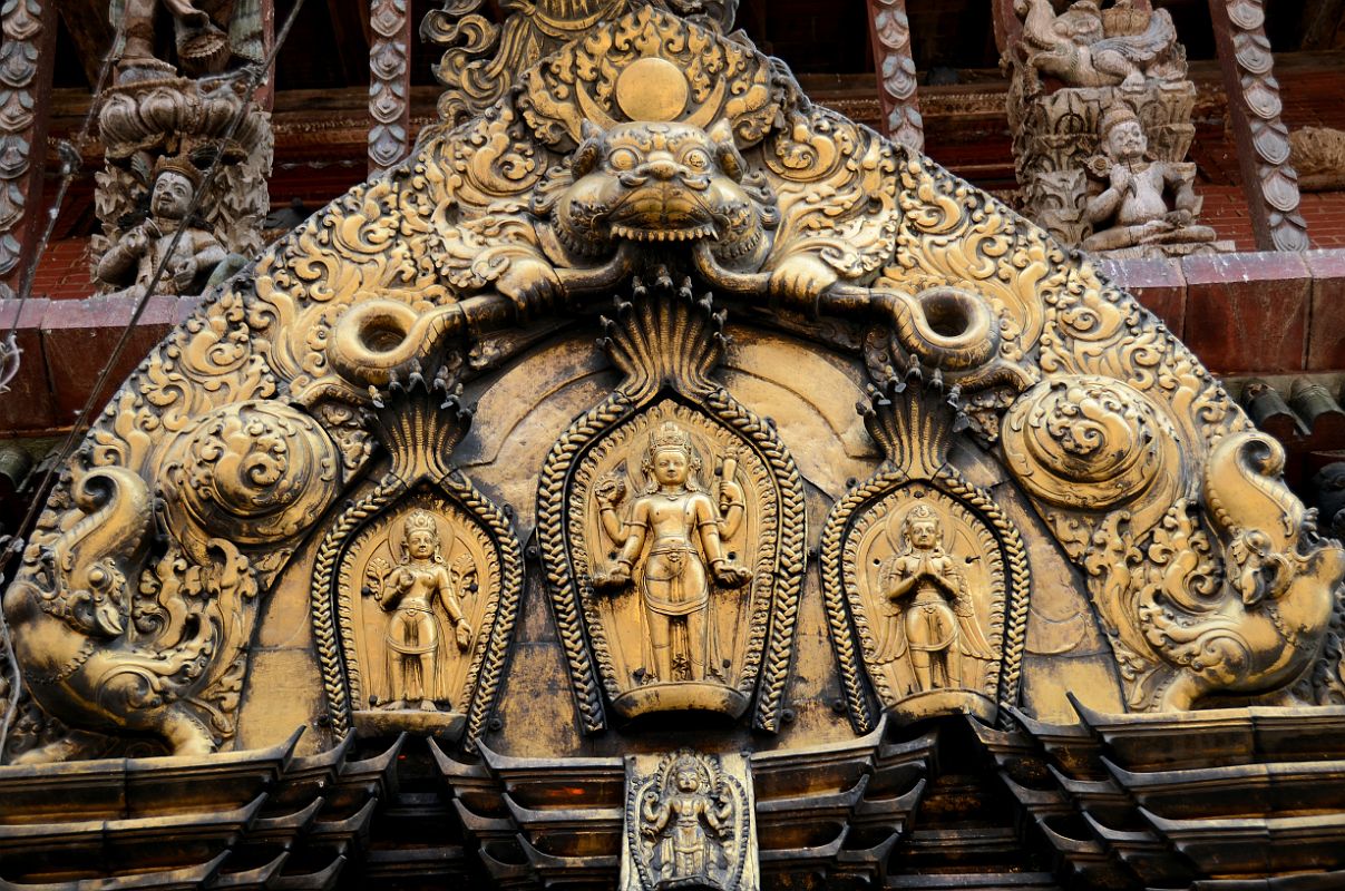 Kathmandu Changu Narayan 18 Lakshmi, Vishnu And Garuda On The Torana Above Main Entrance To Changu Narayan Temple Vishnu is engraved in the brass work of the torana above the main west door of the Changu Narayan Temple in the Kathmandu Valley. To the left is Lakshmi (Laxmi) and to the right is Garuda.